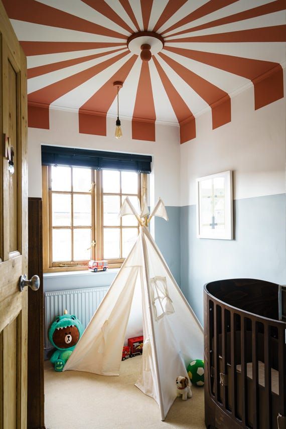 a child's room with a teepee tent in the corner