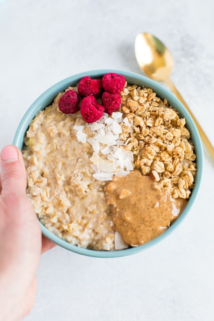 a bowl filled with oatmeal and raspberries