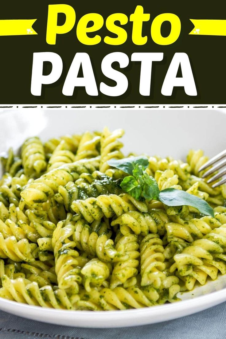 pasta with pesto sauce in a white bowl