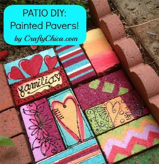 the sidewalk is made out of bricks and painted with colorful patterns, hearts, and words