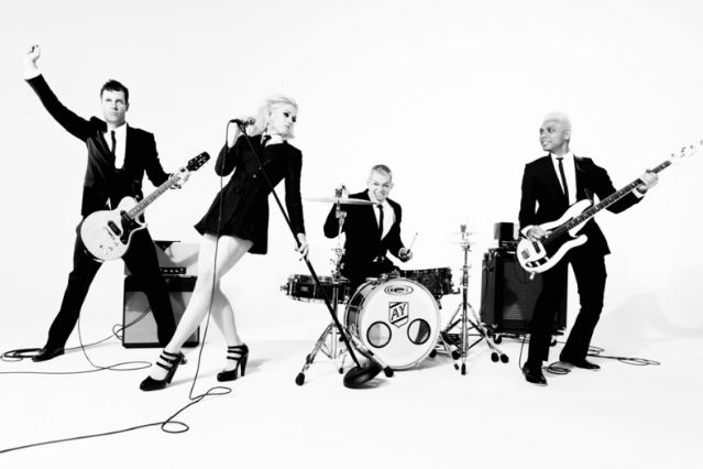 a group of people that are standing in front of guitars and bassets on a white background