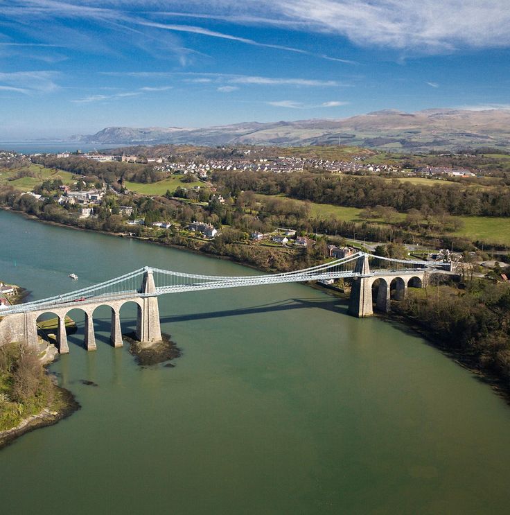 an aerial view of a bridge spanning the width of a river