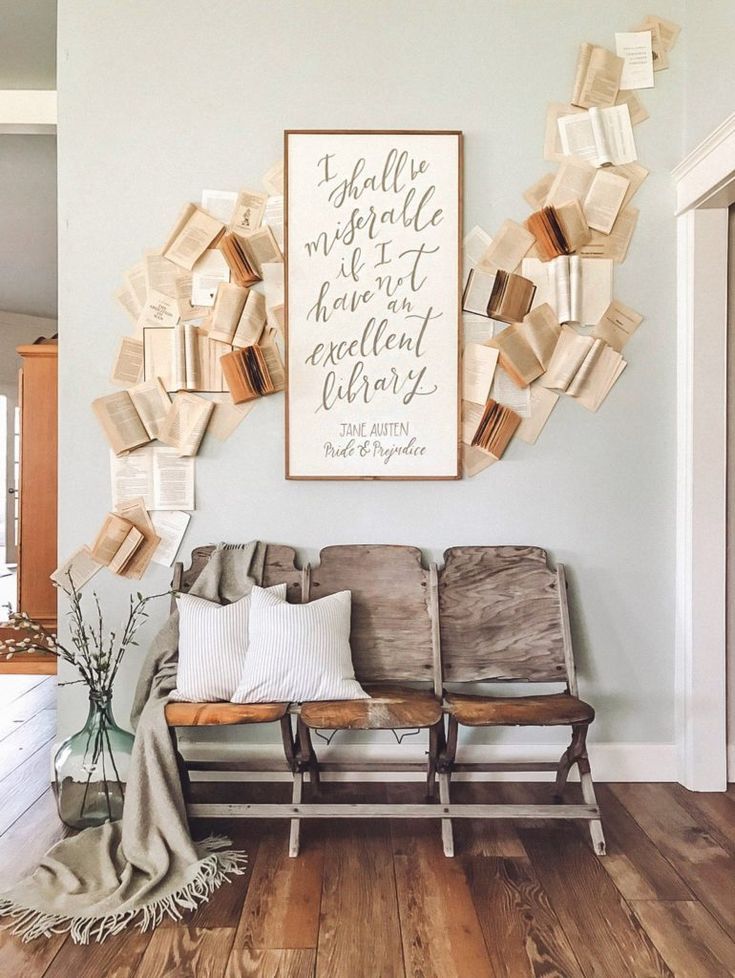 a living room filled with furniture and books on the wall