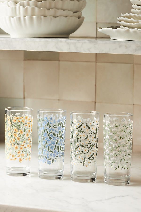 four glasses sitting on top of a counter