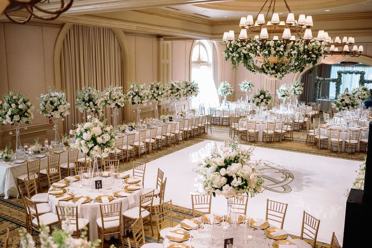 a banquet hall with tables and chairs set up for a formal function in the center