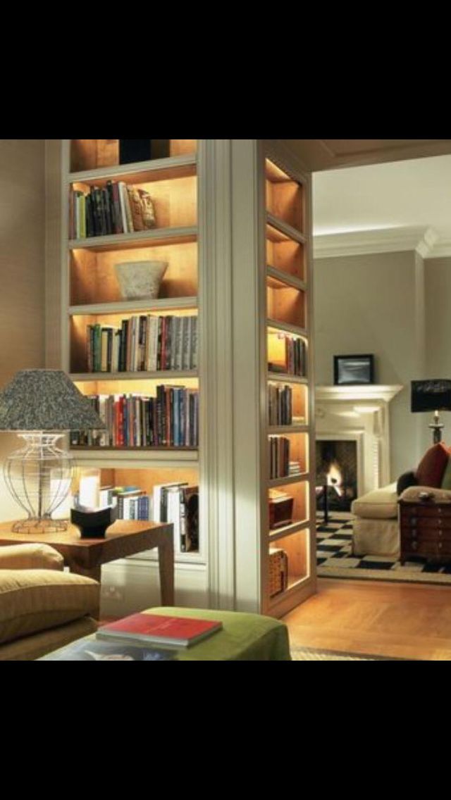 a living room filled with furniture and bookshelves