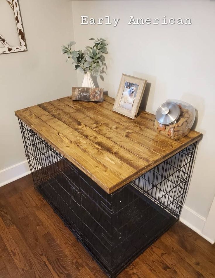 a wooden table with metal cage on top