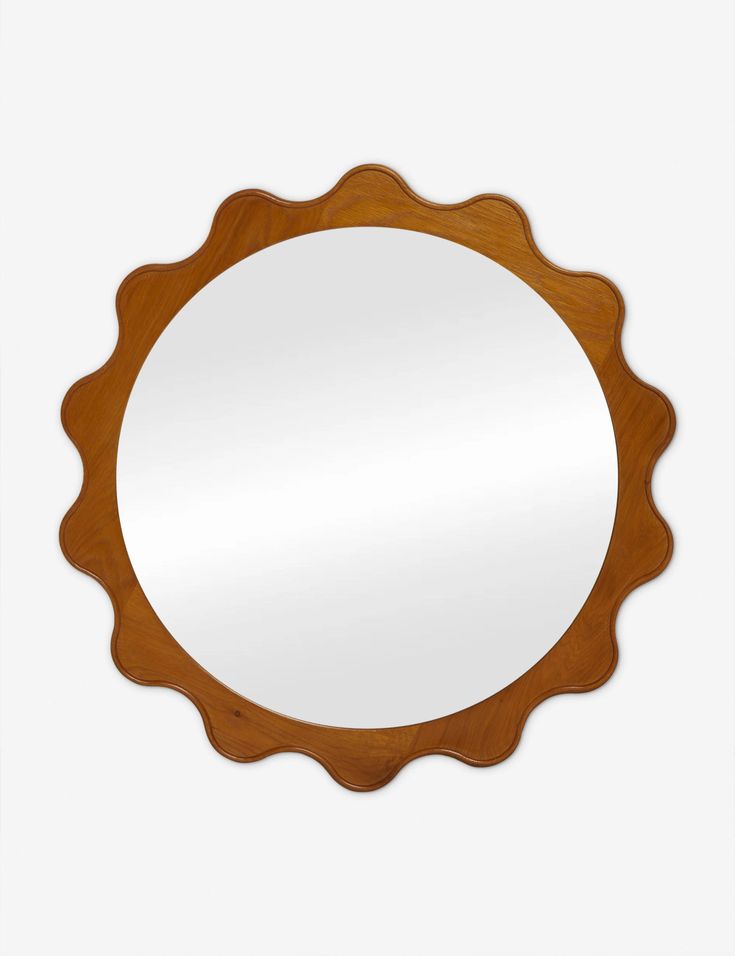 a round wooden mirror sitting on top of a white wall