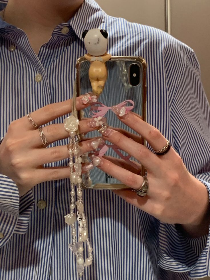 a woman is holding up her phone case