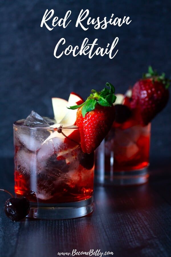 two glasses filled with red russian cocktail and garnished with strawberries on the rim