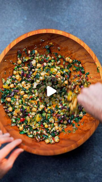 a wooden bowl filled with lots of food