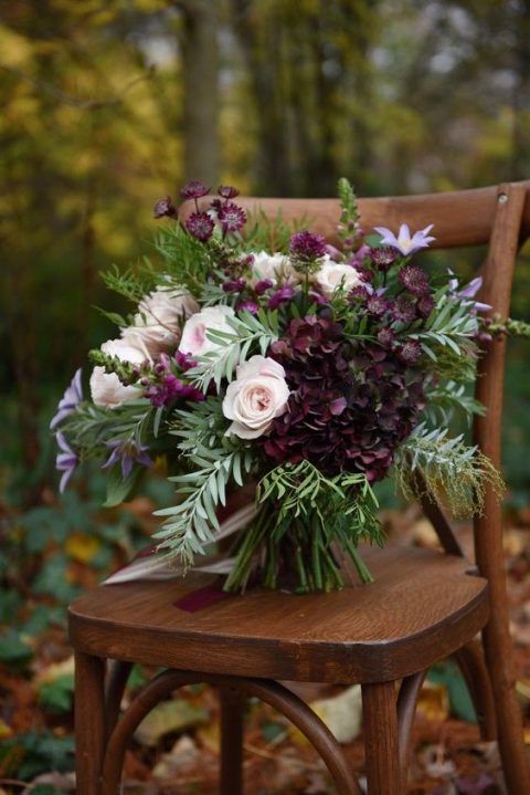 a wooden chair with flowers on it in front of some leaves and trees, the caption reads grandu ziet