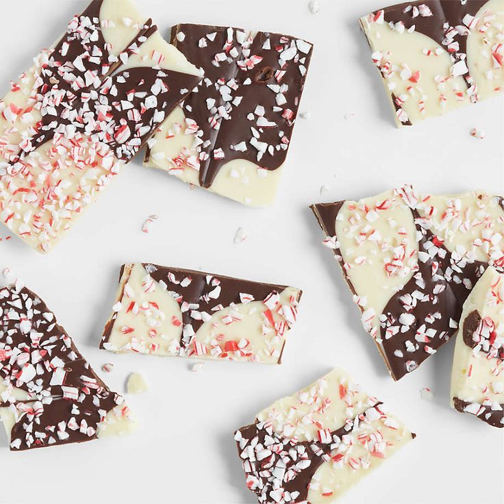 several pieces of chocolate and sprinkles on a white surface