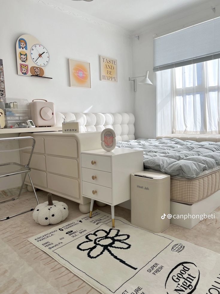 a bedroom with white furniture and lots of pictures on the wall above the dressers