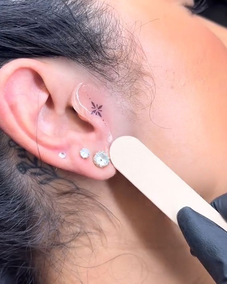 a woman with ear piercings getting her ears pierced