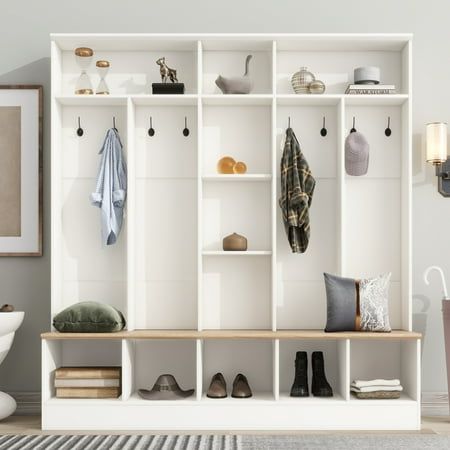 a white shelf filled with shoes next to a wall mounted coat rack in a living room