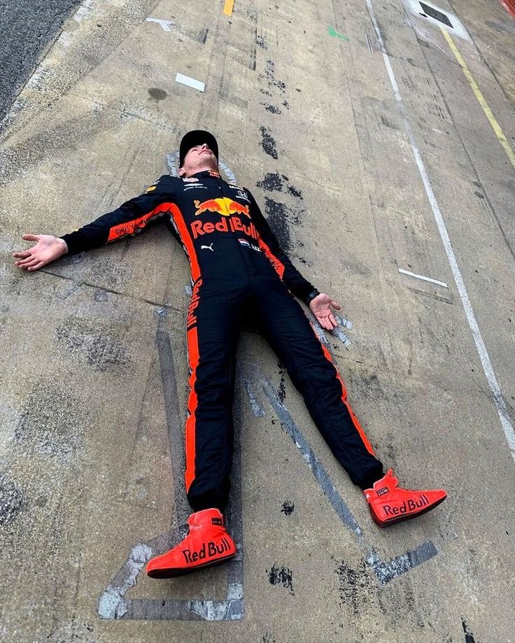 a man laying on the ground with his arms out