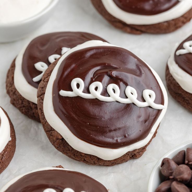 chocolate cookies with white frosting and the word reese spelled on them