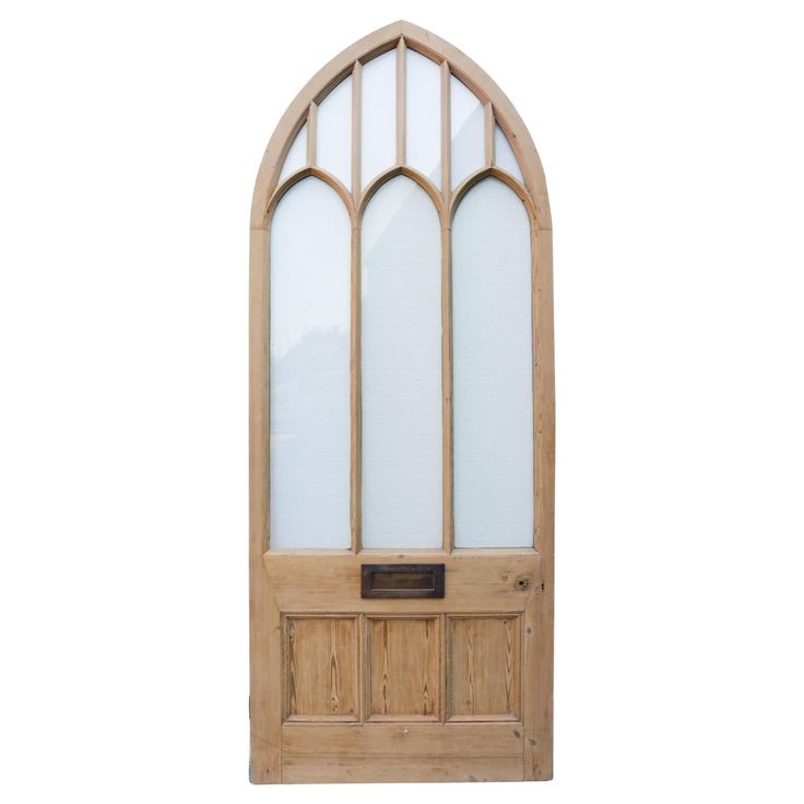 an arched wooden door with glass panels on the top and bottom panel, against a white background