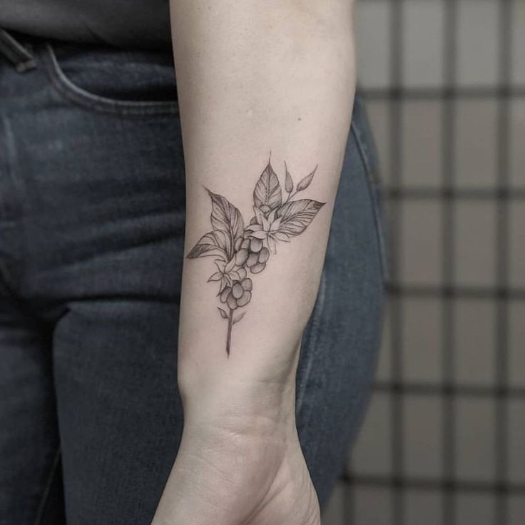 a woman with a flower tattoo on her arm