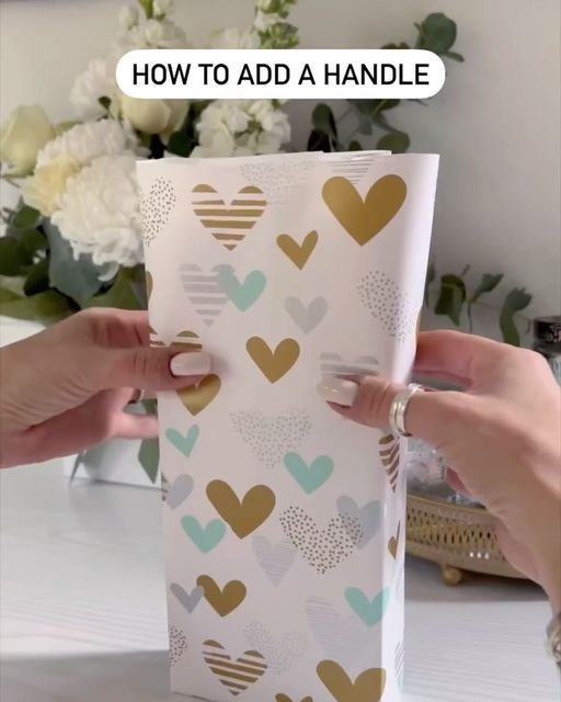 two hands are opening a box with hearts on it and the words how to add a handle