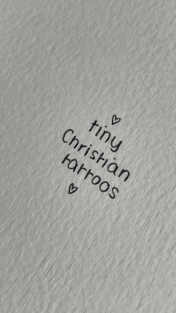 the word tiny christian tattoos written in black ink on a piece of white paper with an arrow