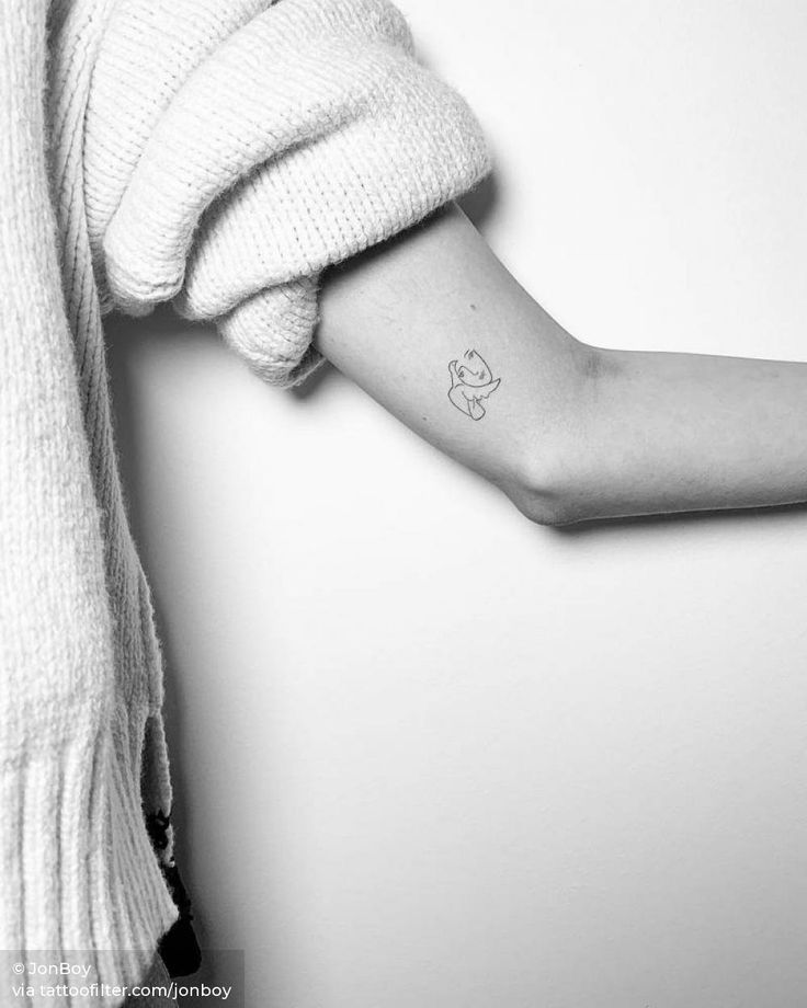 a woman's arm with a small tattoo on the left side of her arm