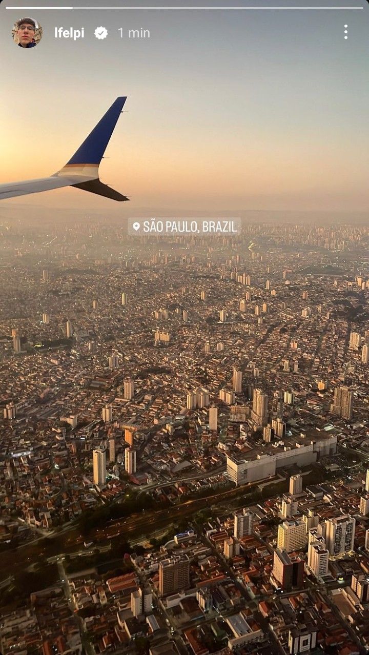 an airplane wing flying over a large city