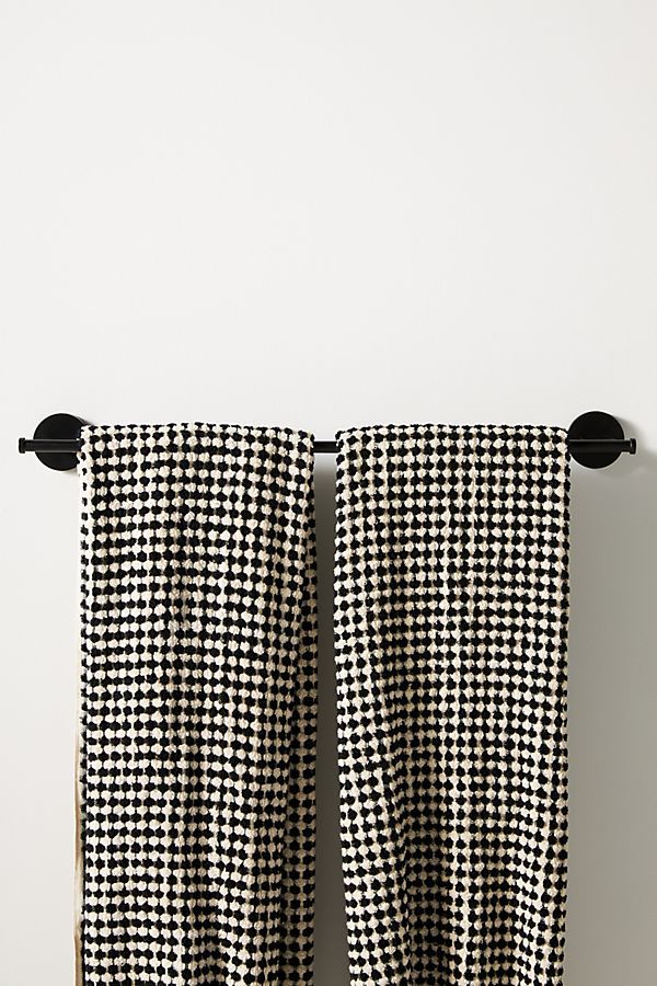 two black and white checkered curtains hanging on the wall