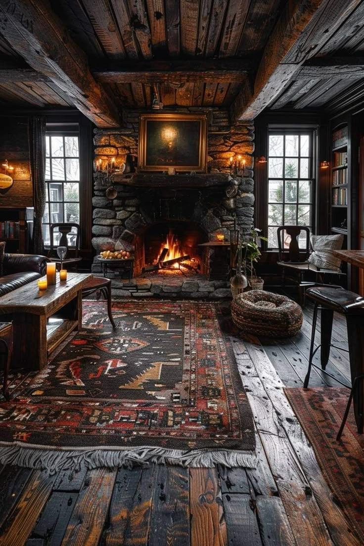 a rustic living room with wood floors and stone fireplace