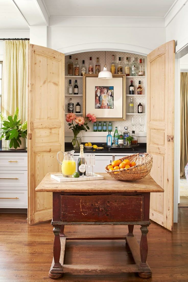 a kitchen with an open door leading into the living room and breakfast bar in front of it