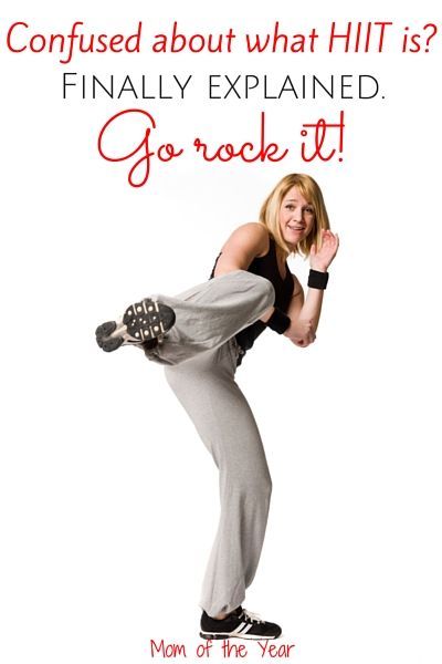 a woman in grey pants and black tank top doing a handstand on her hip