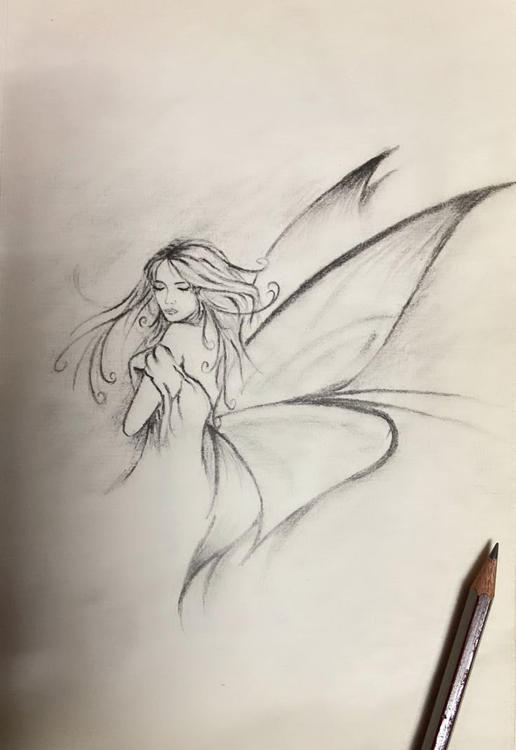 a pencil drawing of a fairy sitting on top of a table next to a pen