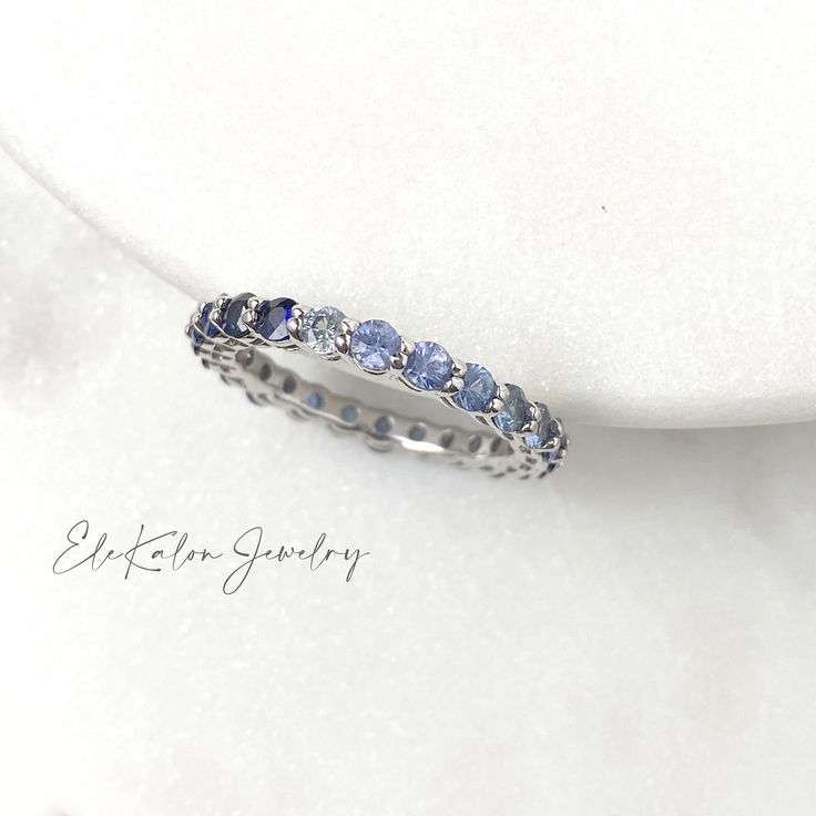 This beautiful minimalist stackable full eternity ring features natural blue or pink sapphire from a gentle pastel tone to vivid saturated color. Made to Order. Ships within 3-4 weeks. - Stone info: natural blue or pink sapphire, 2.5mm round brilliant cut - Total ct weight: approx. 2ctw - Finish: white or rose - Made in 14 karat gold. - Stamp with 14K. Ombre Sapphire Ring, Sapphire Stackable Ring, Getty Wedding, Wishbone Necklace Gold, Sapphire Eternity Ring, Light Blue Sapphire, Celestial Ring, Sapphire Band, Full Eternity Ring