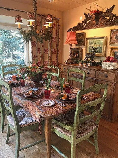 the dining room table is set with place settings for six people and has deer heads on the wall