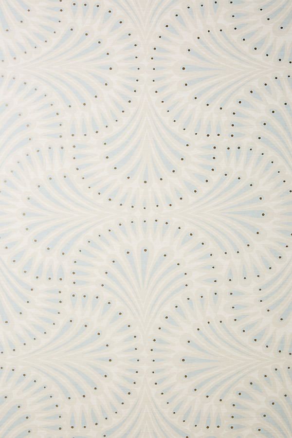 a blue and white wallpaper with small dots on the top, in an ornate pattern