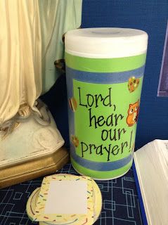 there is a cup that says lord, hear our prayer next to a plate with a cookie on it