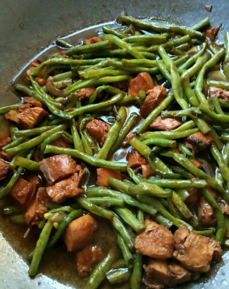 some meat and green beans in a bowl