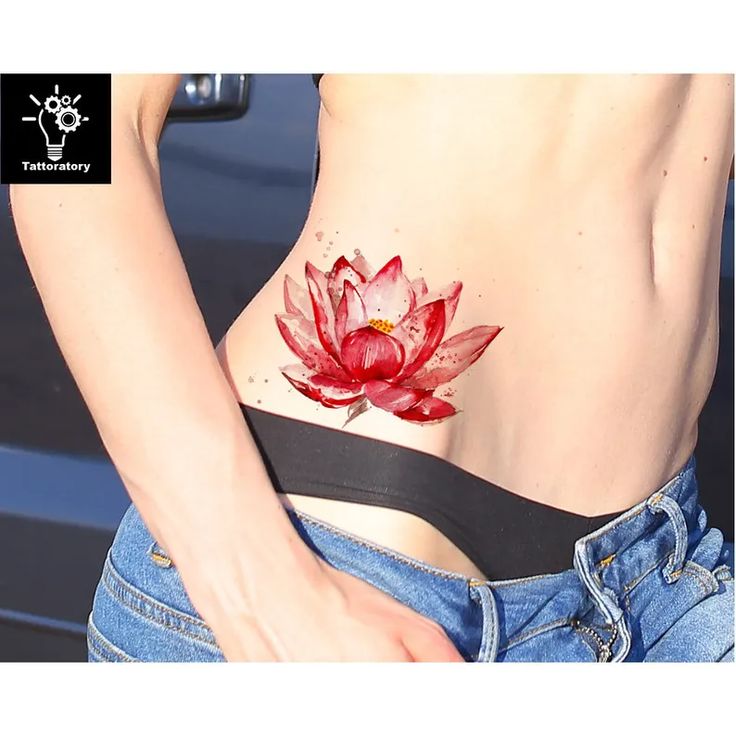 a woman's stomach with a red flower tattoo on her belly and the bottom part of her body