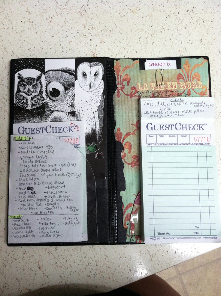 an open guest check book sitting on top of a counter