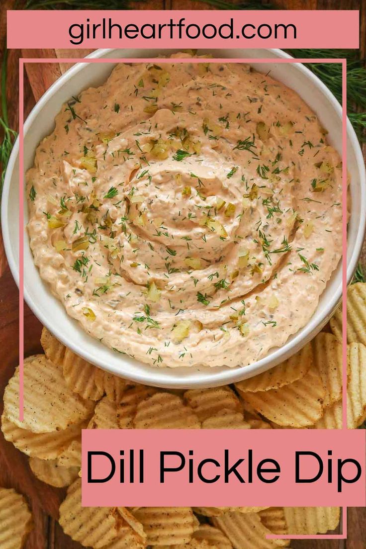 a white bowl filled with dill pickle dip surrounded by crackers