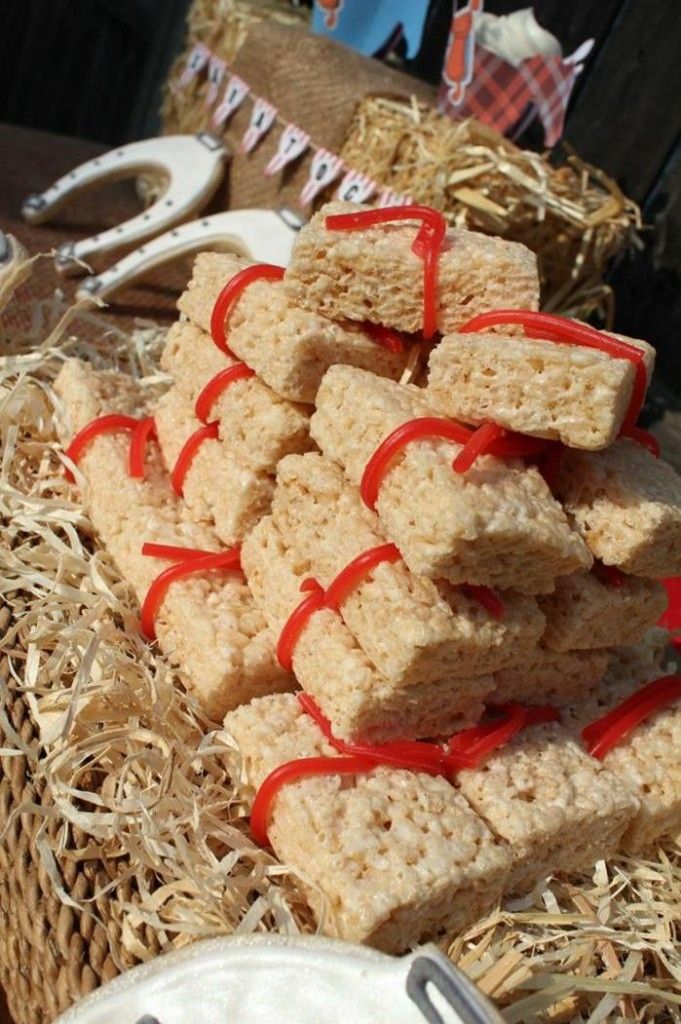 some kind of food that is on a table with straw and red ribbon around it