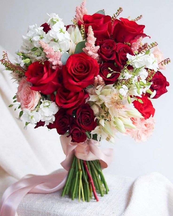 a bouquet of red, white and pink flowers