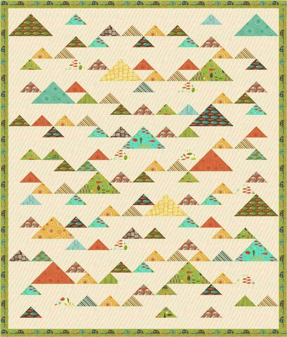 a quilt pattern with many different colored triangles on the front and back, all in green