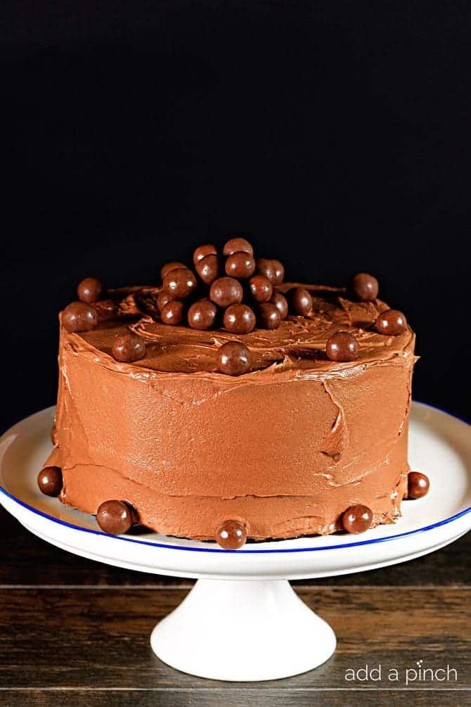 a chocolate cake sitting on top of a white plate next to a black background with the words, naked chocolate cake