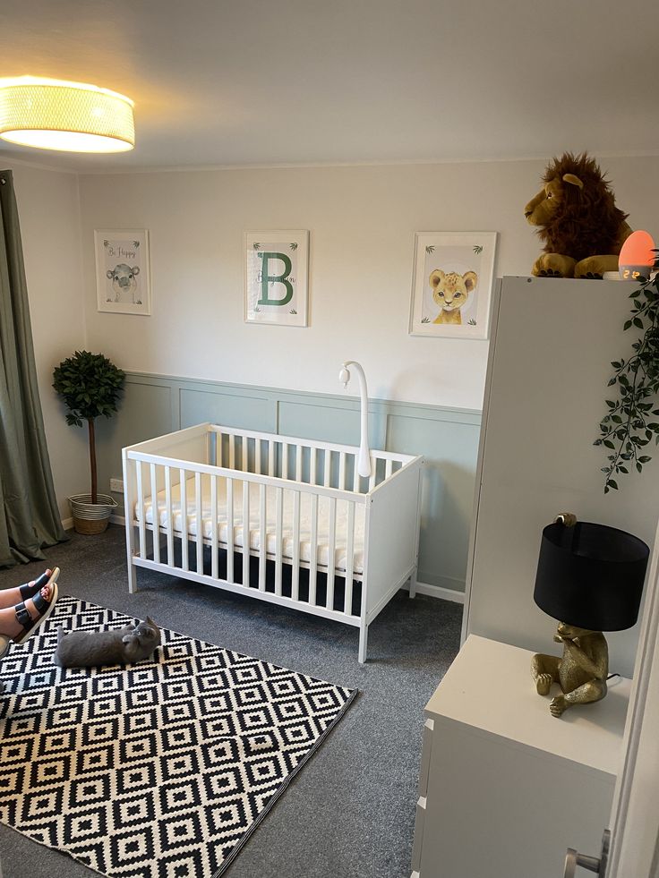 a baby's room with a crib, dresser and bed