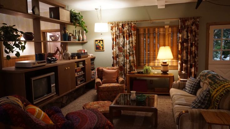 a living room filled with lots of furniture and a lamp on top of a table