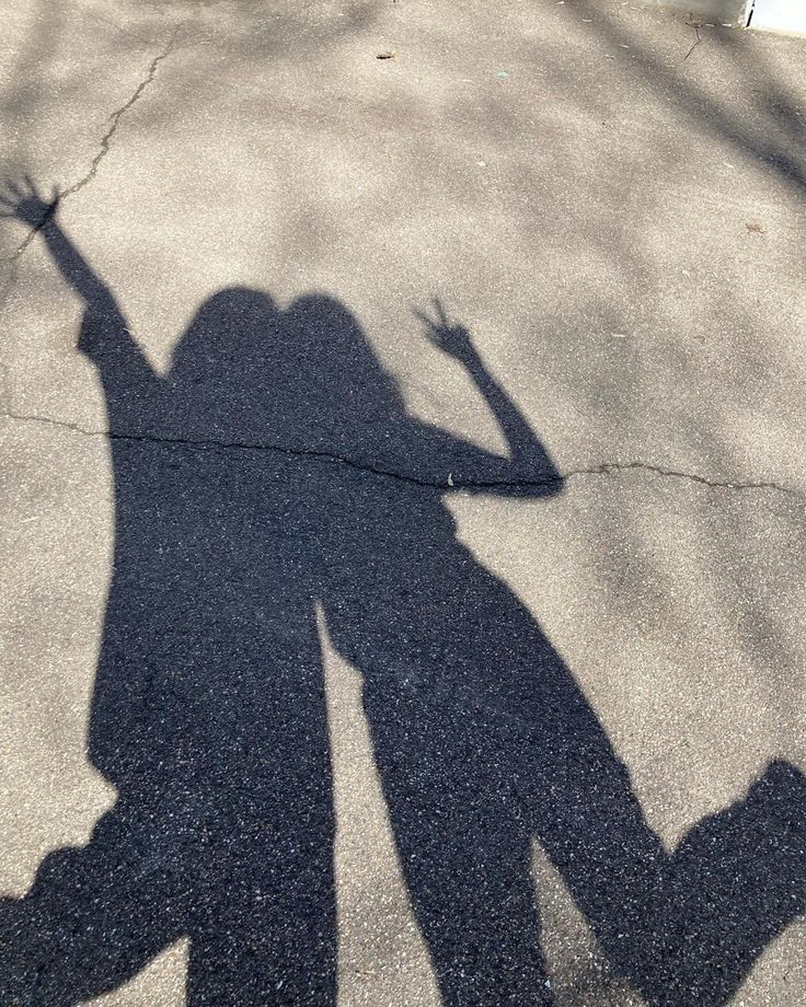 the shadow of a person holding a skateboard