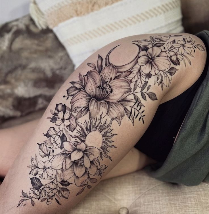 a woman is laying on the couch with her legs crossed and flowers all over her body