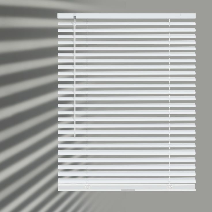 the shadow of a window with white blinds on it's side is cast onto the wall